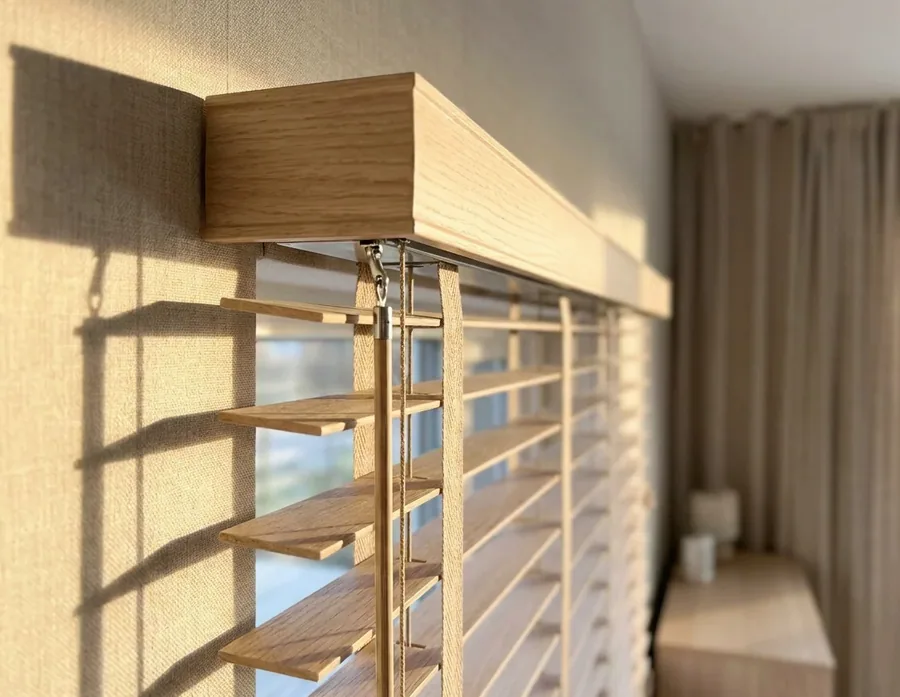 Close-up of a blind headrail, tilt mechanism and cords — the parts a repair puts right